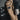 Person wearing a brown yoga mat bag with a visible brand logo against a blurred background